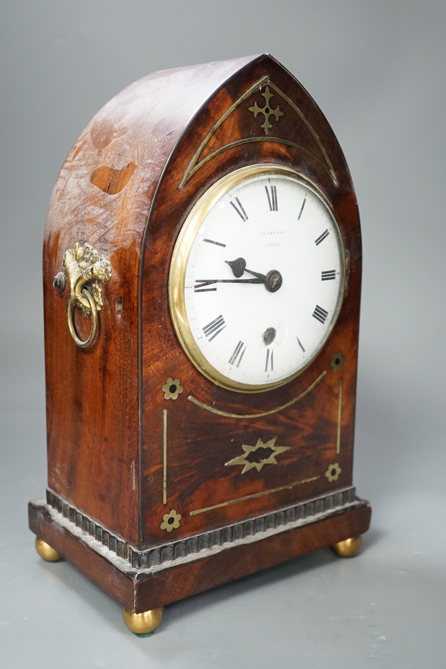 A Clements of Oxford brass inset mahogany lancet timepiece, with pendulum. 30cm high